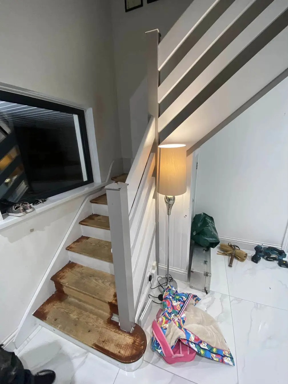 Before: painted staircase with bare treads and closed balustrade